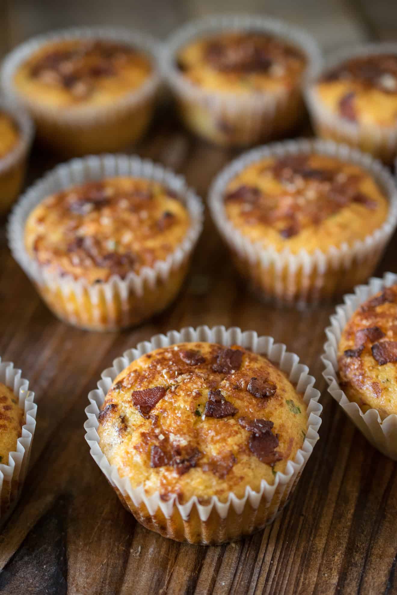 A collection of bacon cheddar corn muffins on a board