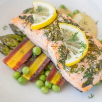 A closeup showing fresh lemon slices and dill
