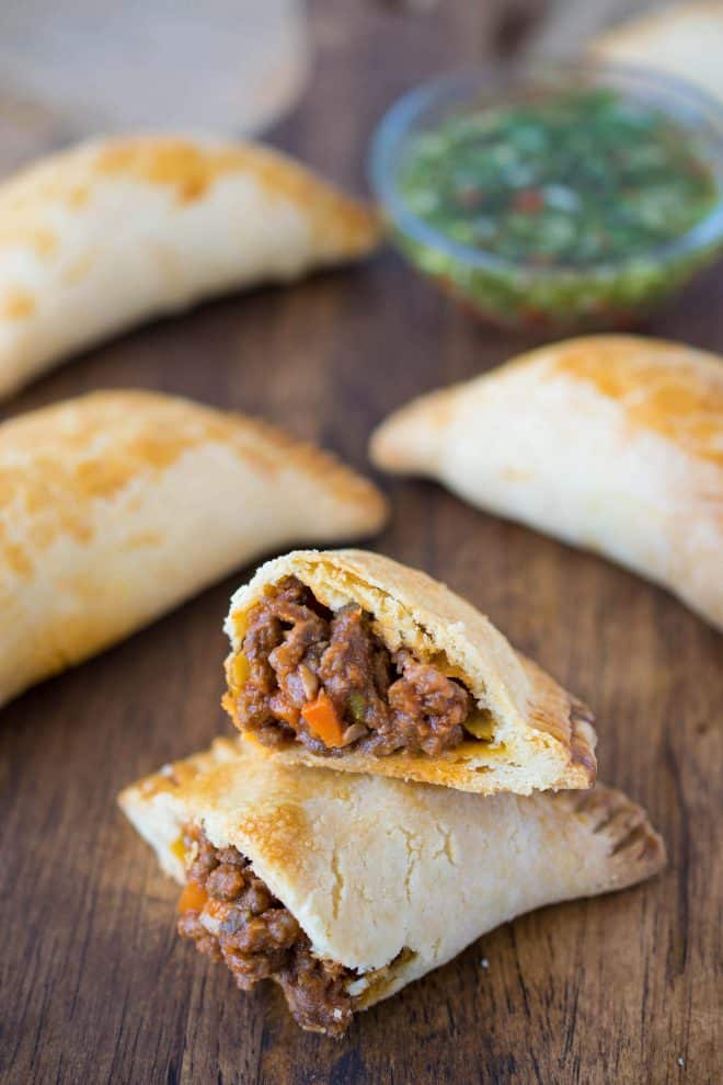 An empanada cut in half showing the beef and mushroom filling