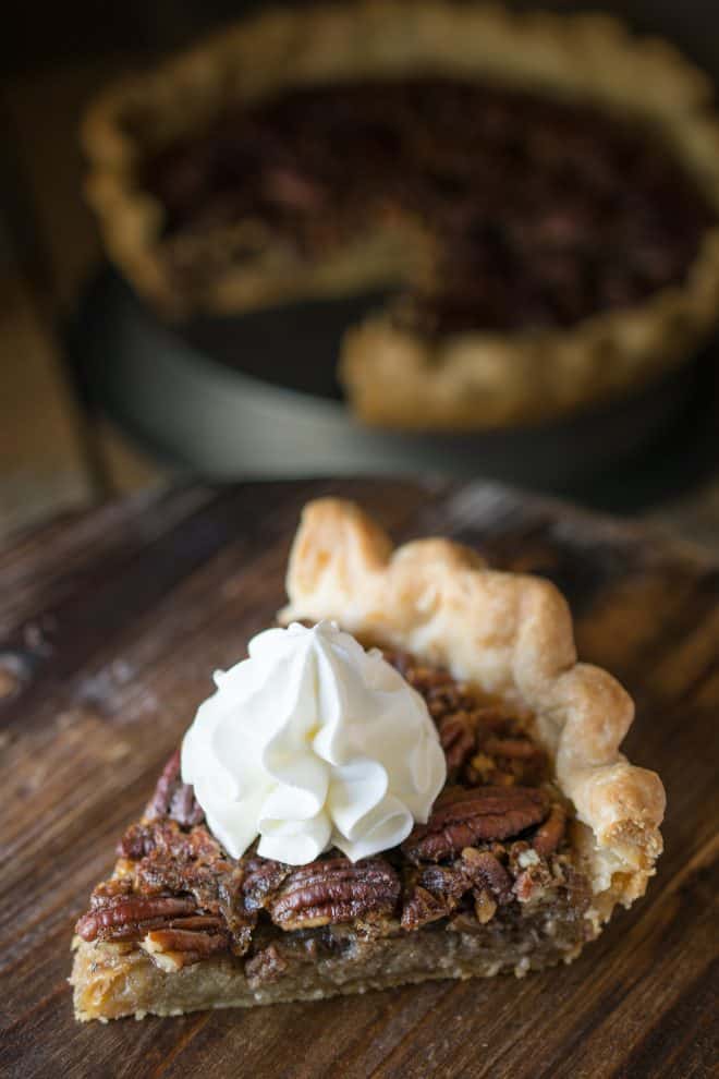 Bourbon Pecan Pie A slice of Bourbon Pecan Pie on a serving board