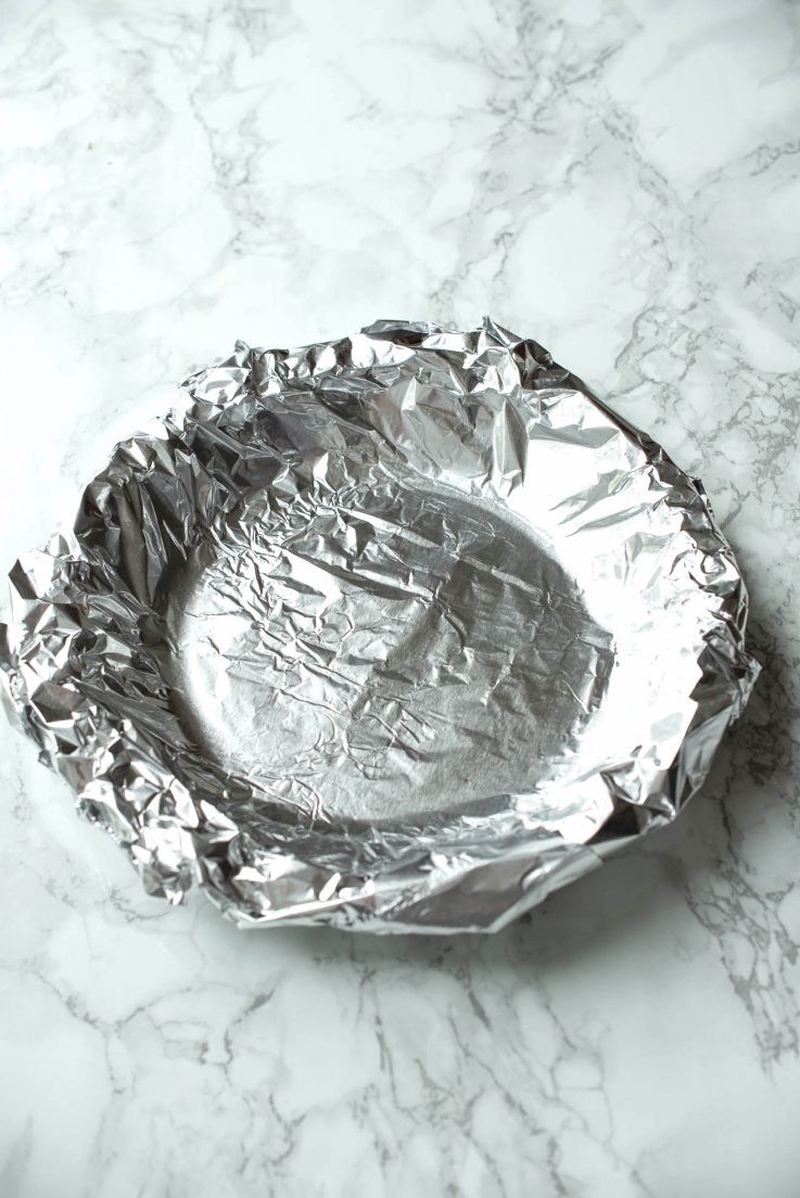 Bourbon Pecan Pie A pie crust covered with foil for blind baking