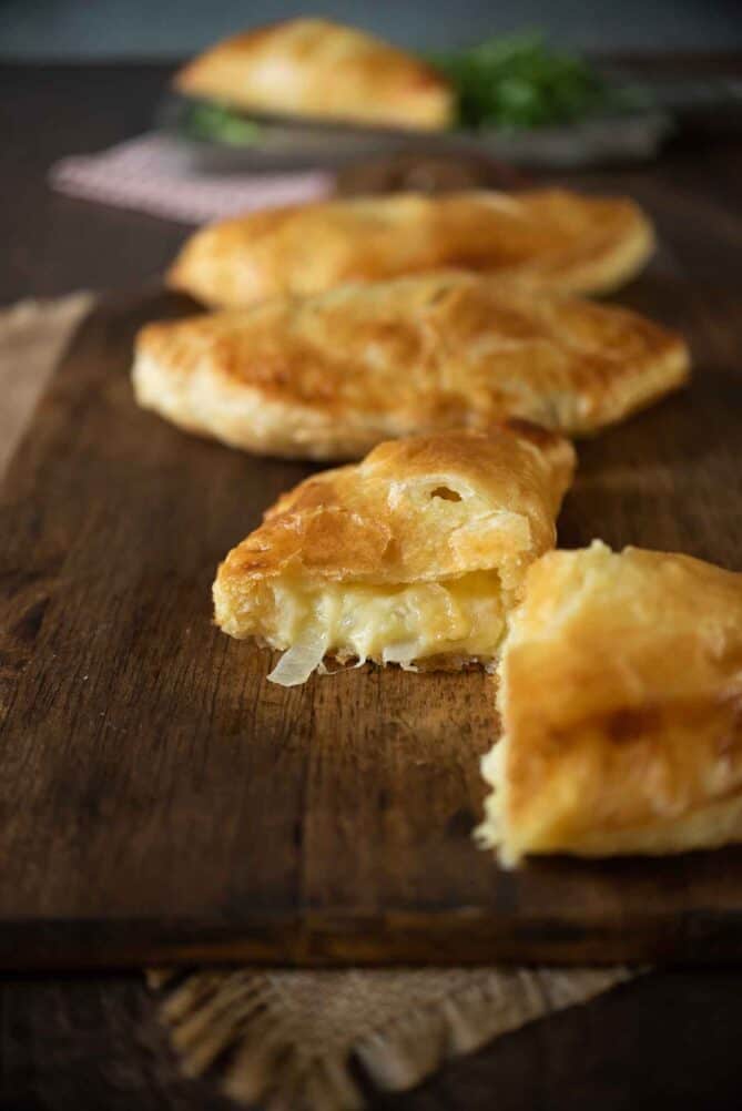 The inside of a cheese and onion pasty with melted cheese