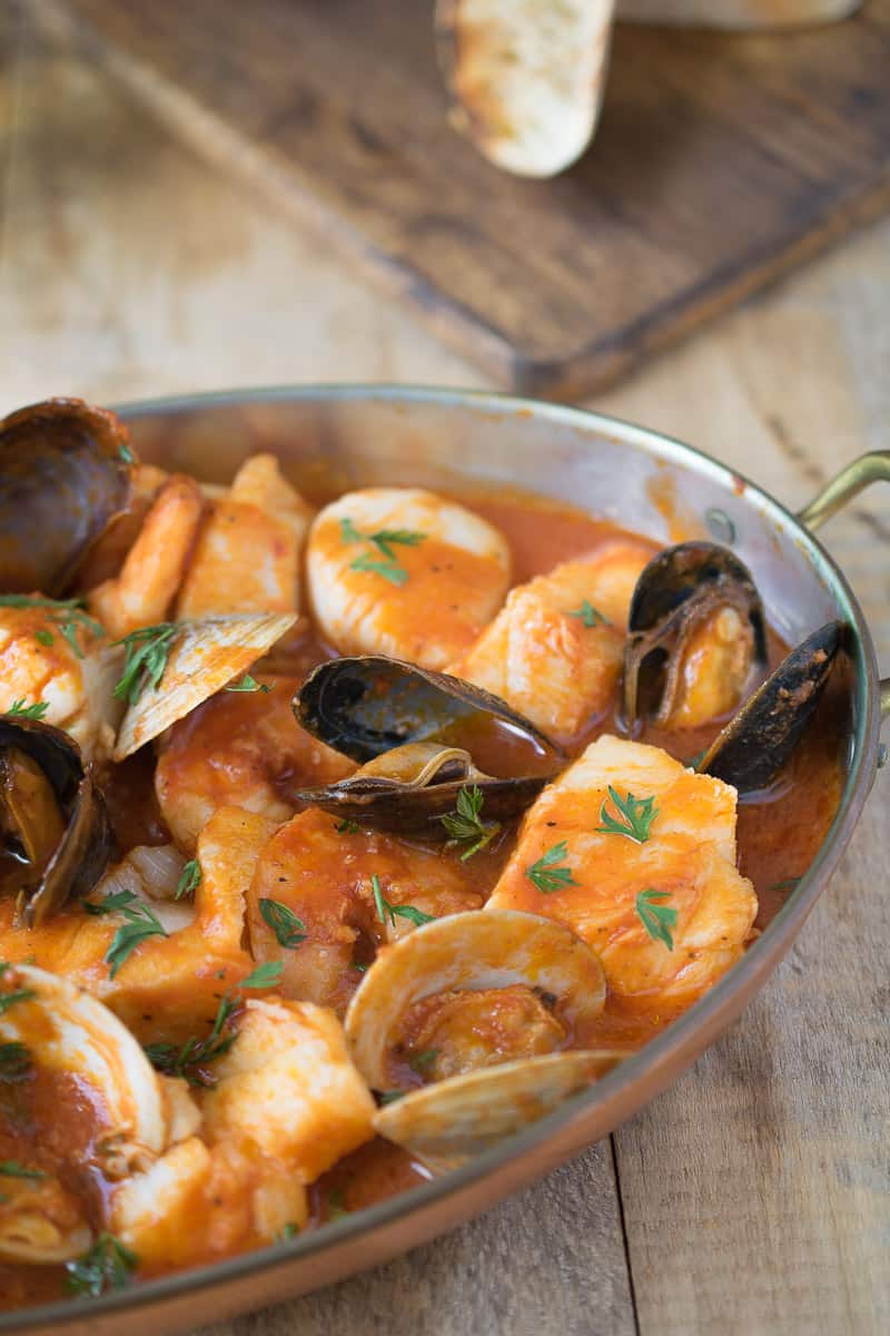 A close showing a juicy mussel, clams, fish and scallops