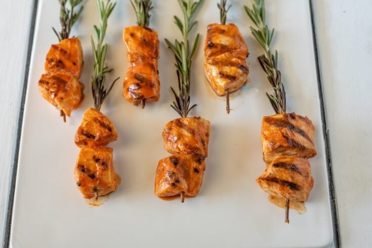 6 pieces of grilled chicken on rosemary skewers