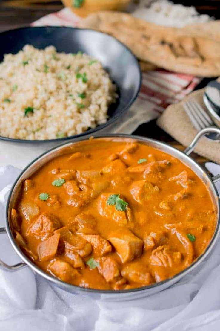 Chicken tikka masala ready to be eaten with rice and naan bread