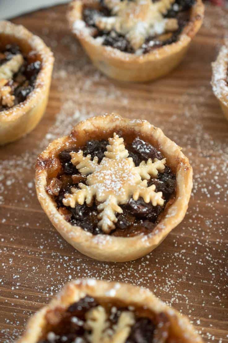 A closeup of a pie showing the decorative pastry snowflake