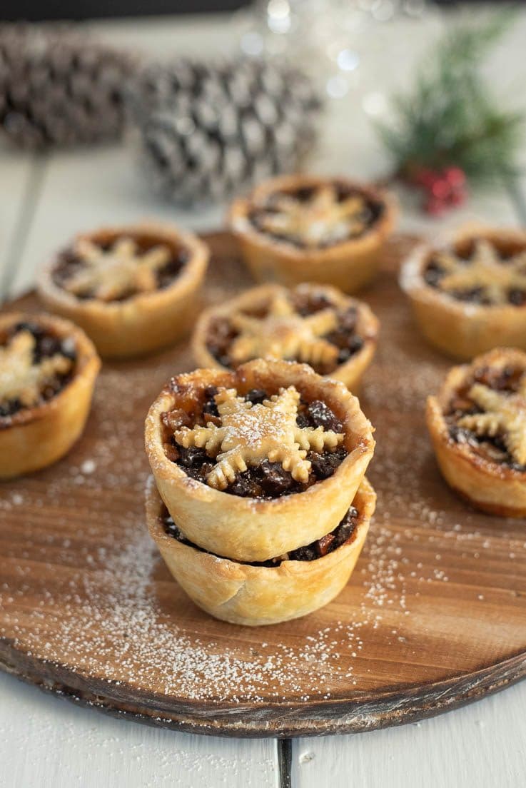 Pies stacked on a wood board