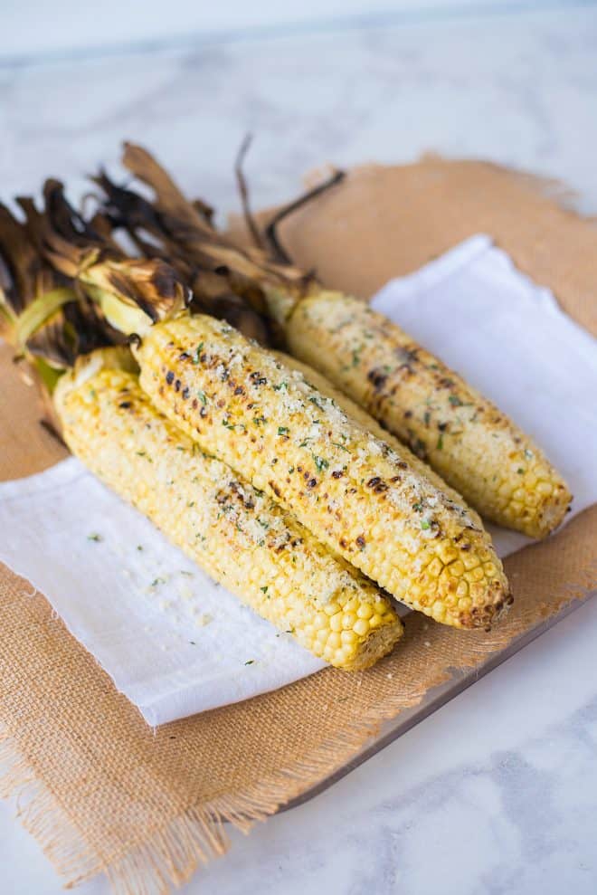 3 corn cobs with garlic butter, Parmesan and basil