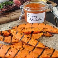 Grilled sweet potatoes with curry ketchup, steak and corn