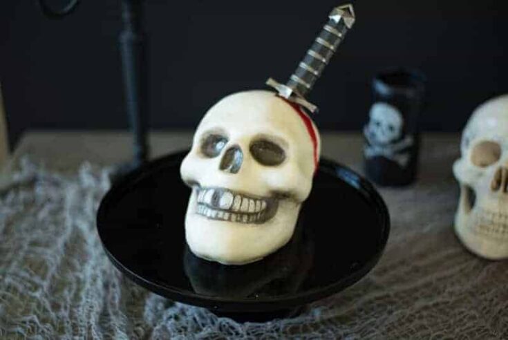 This Halloween skull and dagger cake is a fun and spooky centerpiece that will be sure to scare any Halloween partygoers. This cake can also serve as desserts for your guests, if they dare to eat it.