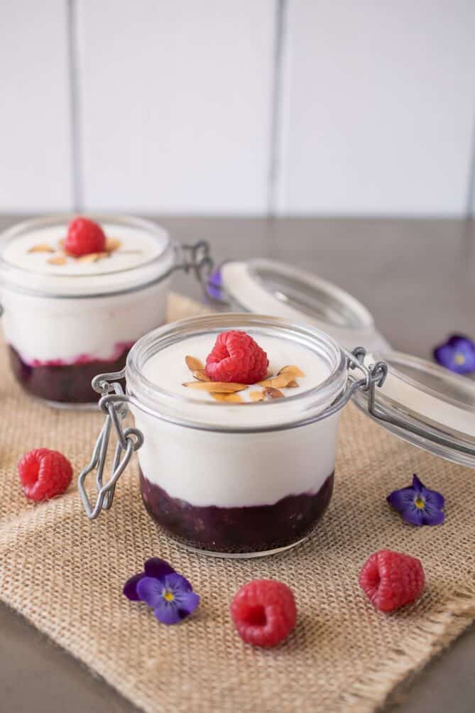 A jar with fruit topped with yogurt
