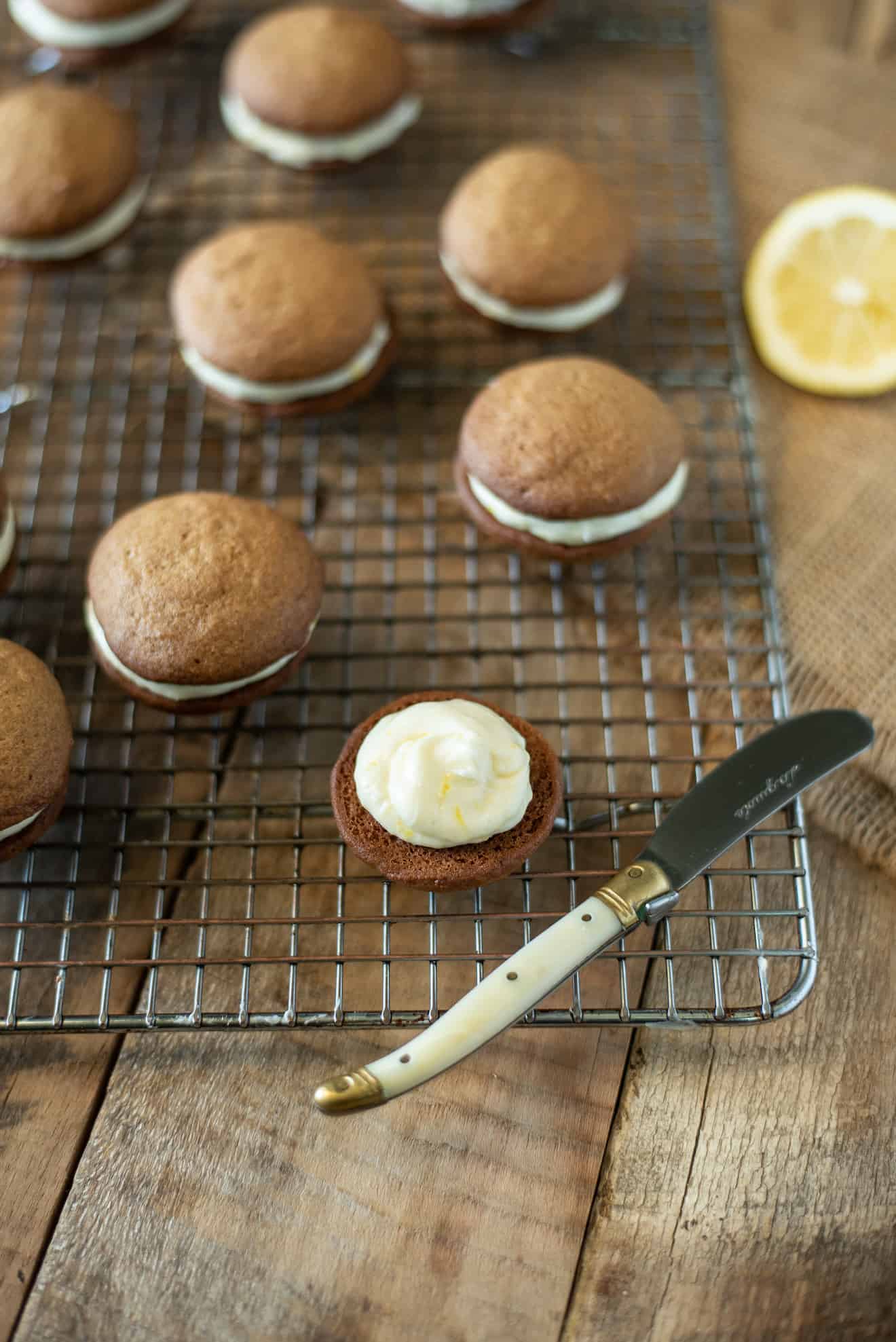 Lemon ginger cream spread onto half of a cookie