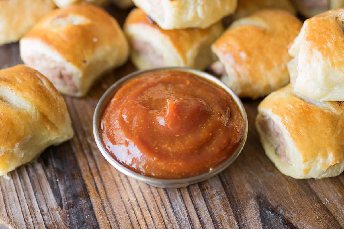 If you have guests coming over for drinks, or just feel like having something to nibble on, these sausage rolls are perfect for both. I may have had a couple for breakfast one morning while no one was looking. The sausage roll is Britain's favorite snack or light meal. There's something about biting into soft, crispy puff pastry that you don't get from anything else, then you get through the pork filling that is flavored with sweet apple and sage. The only thing that makes these better is the curry ketchup because you have to have something to dip into.