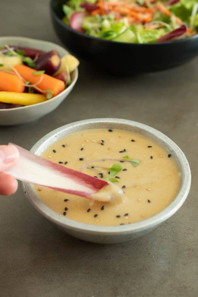 Dipping red Belgian endive into miso dip