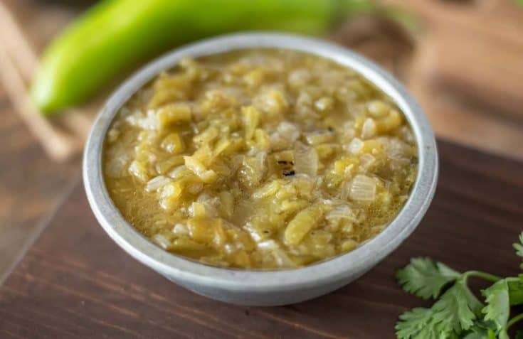 Chopped hatch green chiles in a sauce in a grey bowl