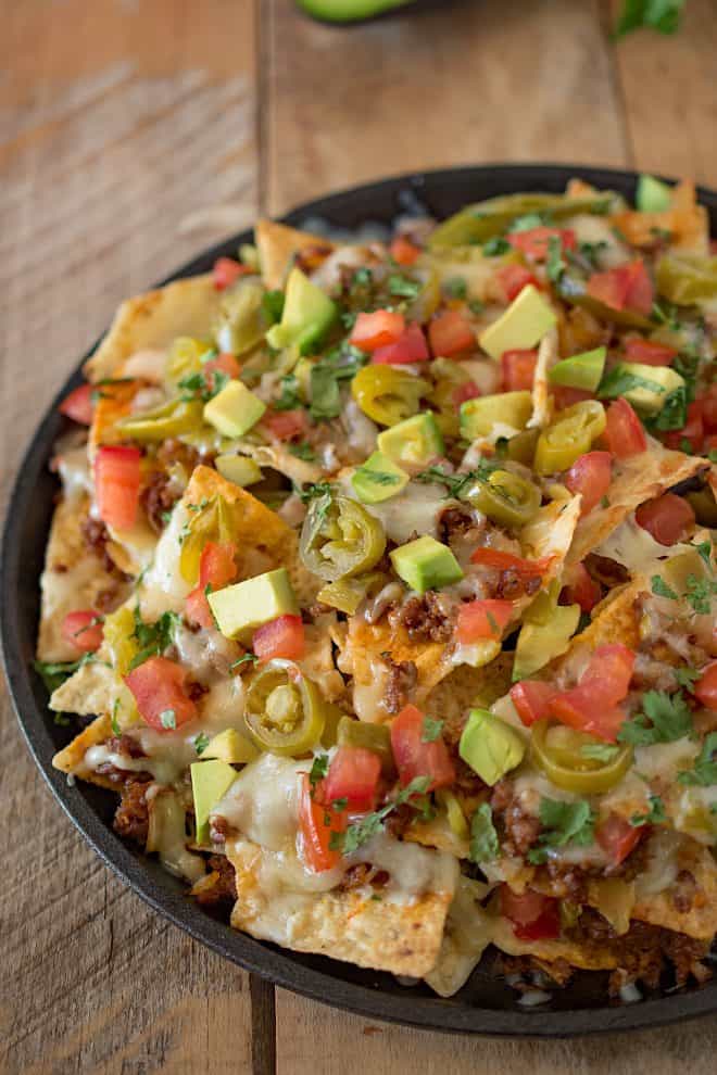 A closeup showing the green avocado, jalapeño, tomato and meat