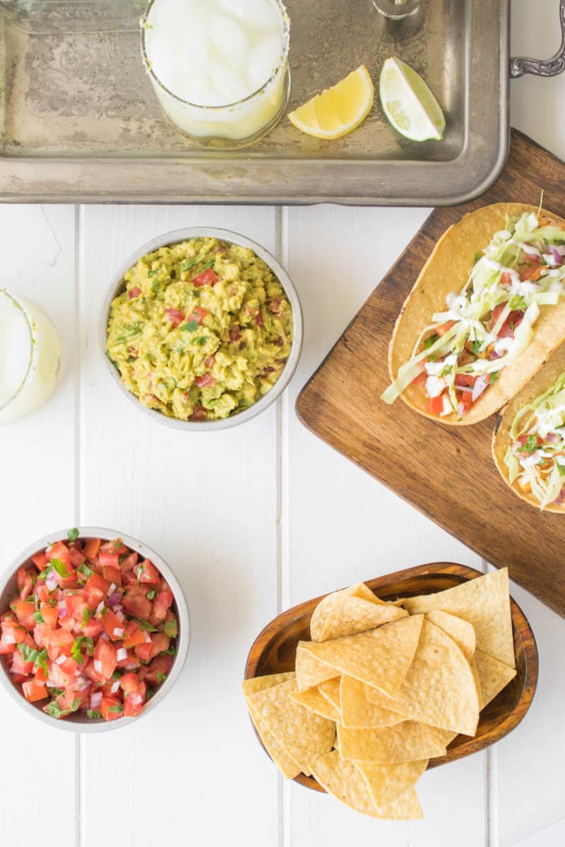 Guacamole, salsa, chips, tacos and a margarita