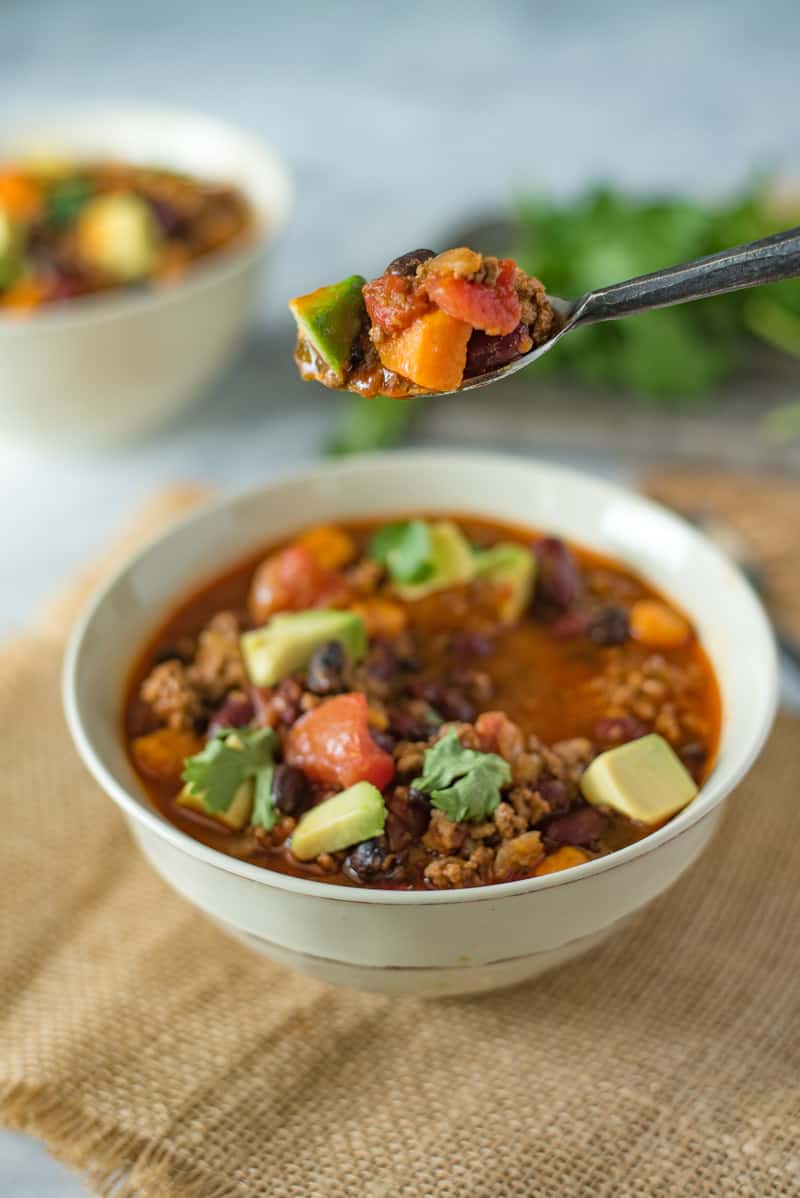 A spoonful of beef chili waiting to be eaten