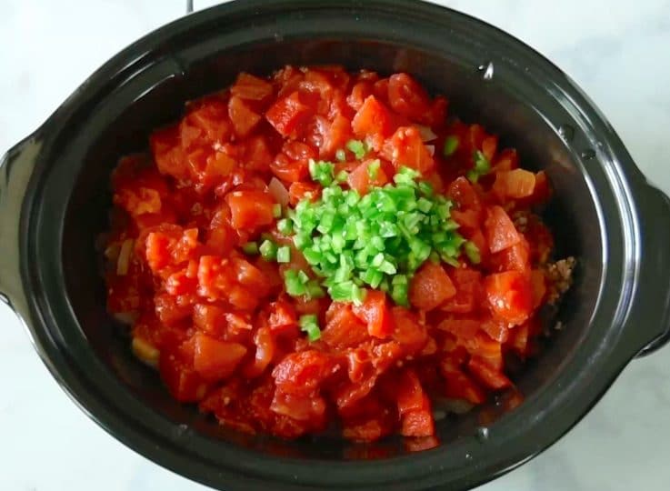 Diced tomatoes, jalapeño and beef stock are added