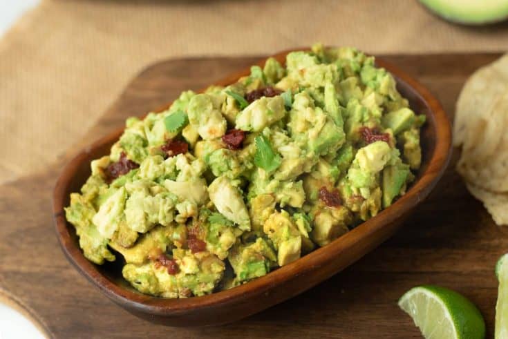 Guacamole made chunky with flecks of chipotle peppers