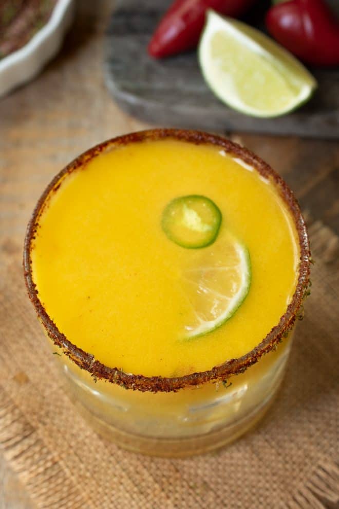 The drink from above showing the lime and jalapeño garnish and spicy salt rim