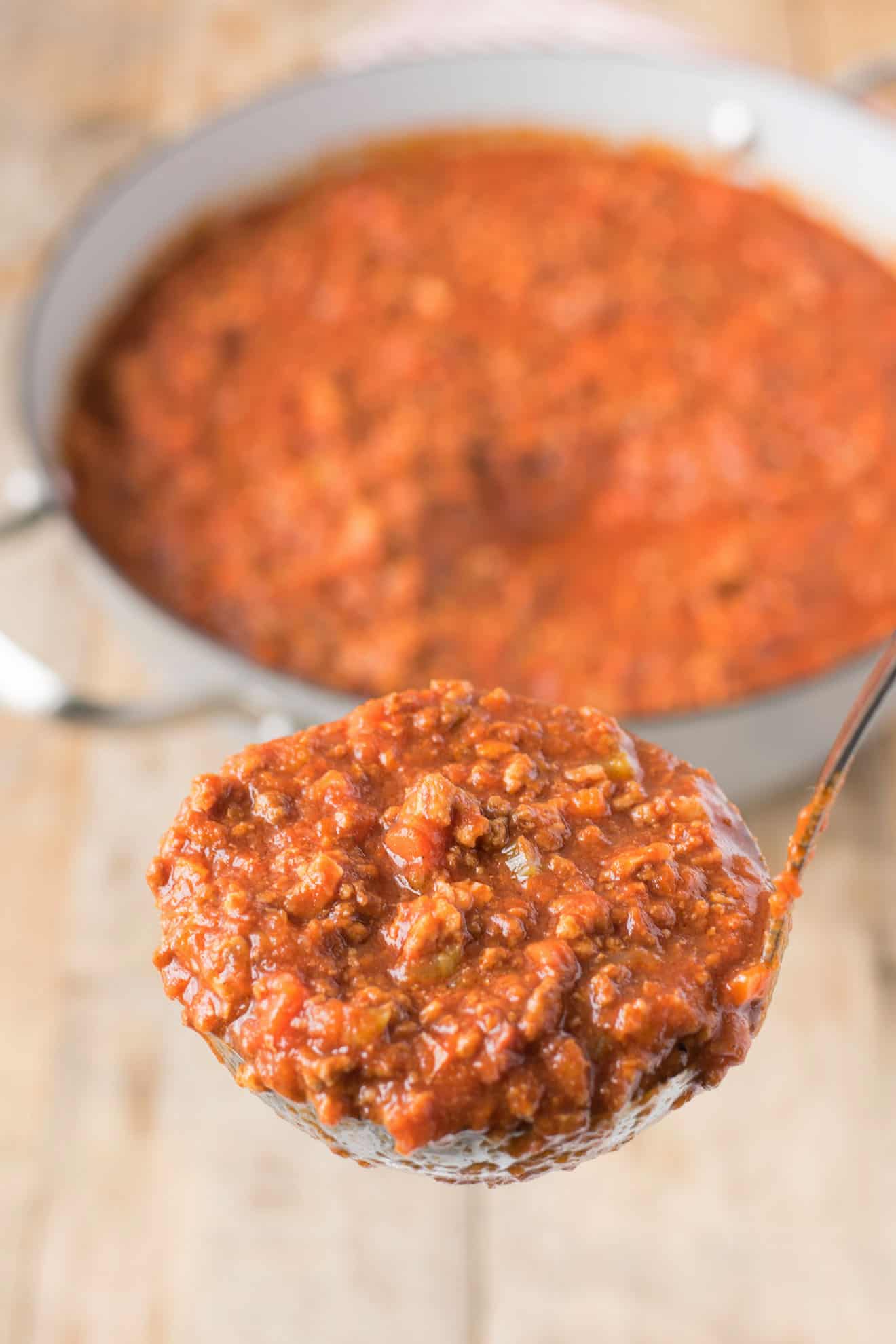 A ladle full of Bolognese sauce