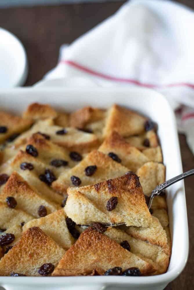 Scooping out a slice of bread pudding