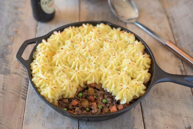 Fluffy and piped mashed potato on top of ground beef and vegetables