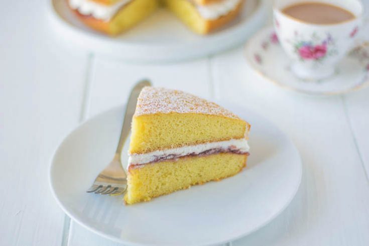 A slice of sponge cake sandwiched with jam and whipped cream