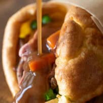 A fluffy Yorkshire pudding wrapped around roast beef and vegetables